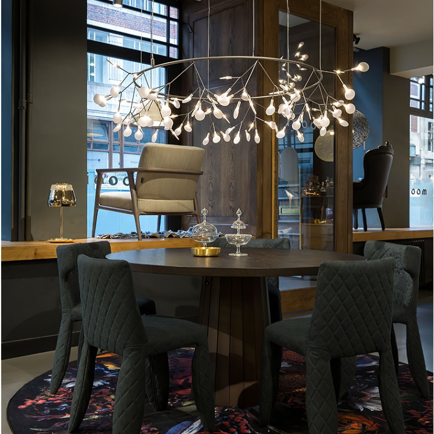 Modern Firefly Leaf Chandelier Over Round Dining Table