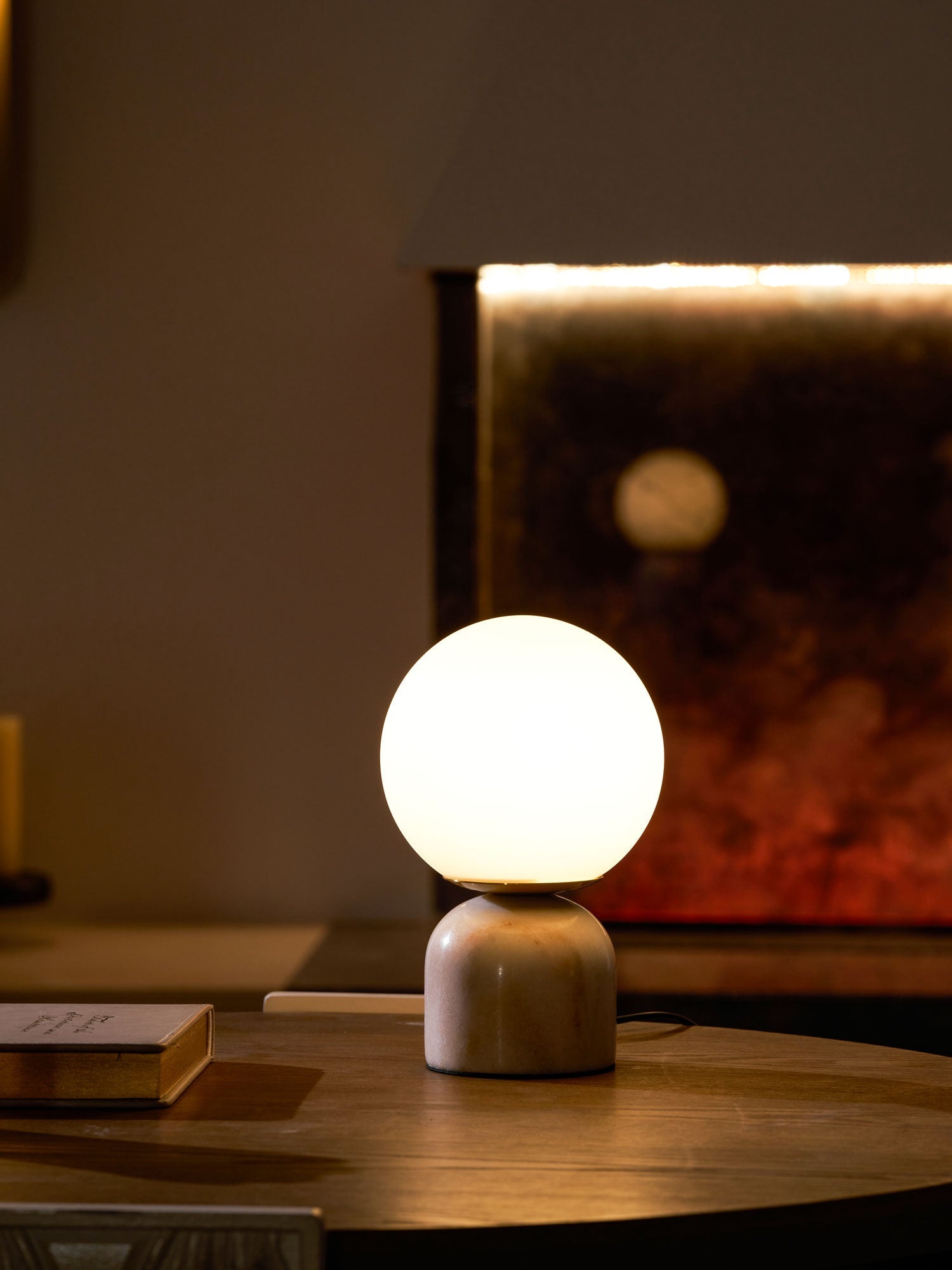 Warm Glowing Marble Globe Table Lamp Over Side Table
