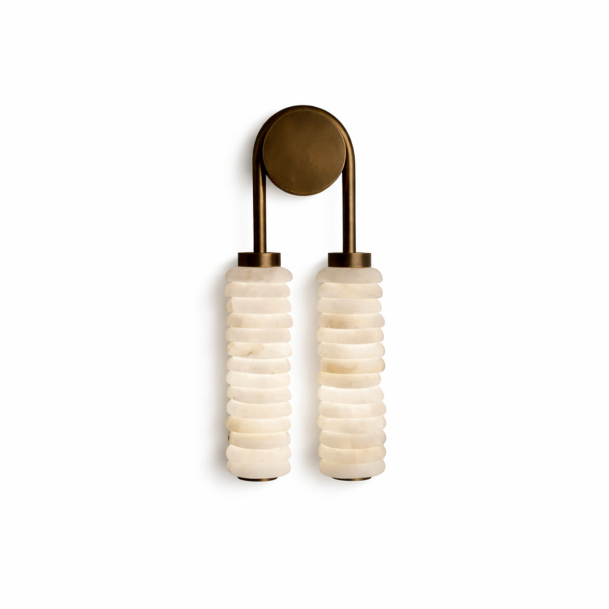 Minimal front shot of twin ribbed alabaster wall lamp with aged brass hardware
