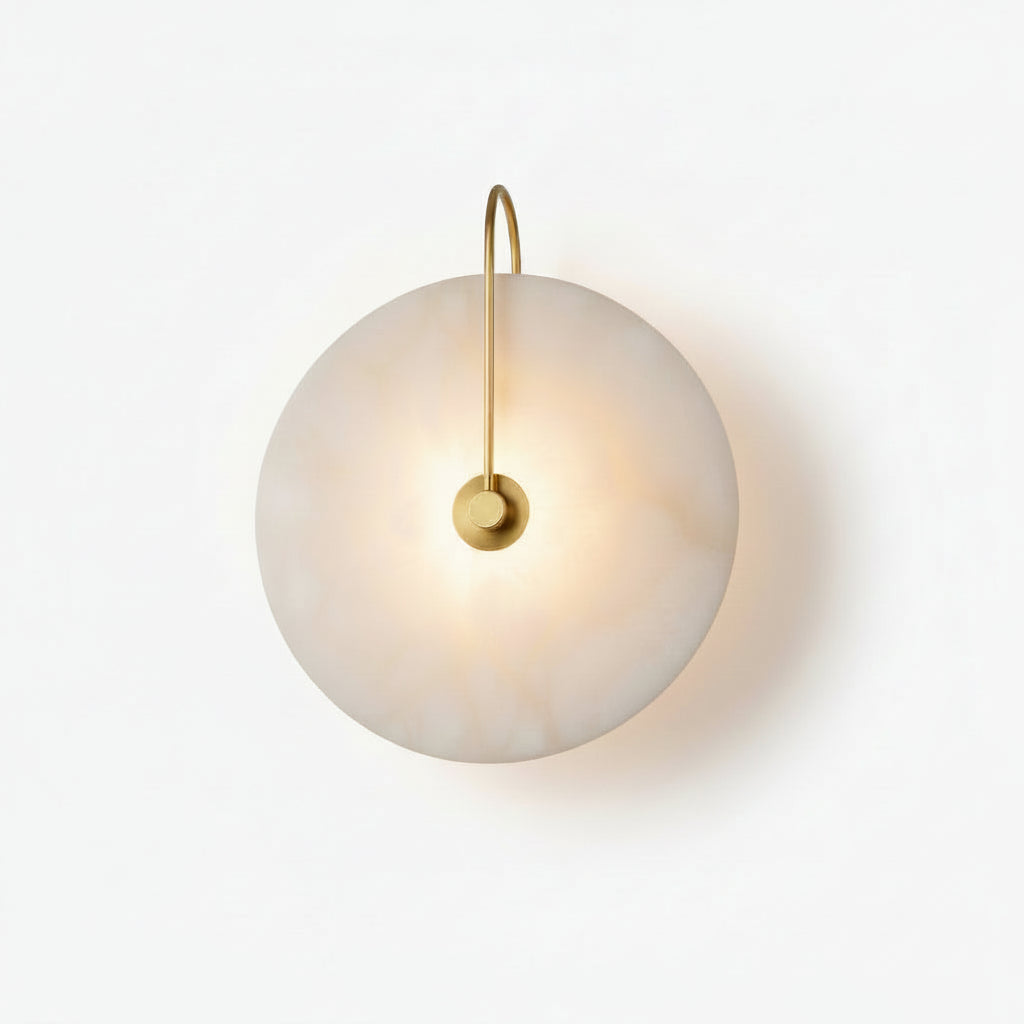 Illuminated alabaster disc wall sconce brass fitting isolated plain white backdrop