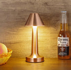 Illuminated Rose Gold Cordless Touch Table Lamp Studio Shot on Wood Surface
