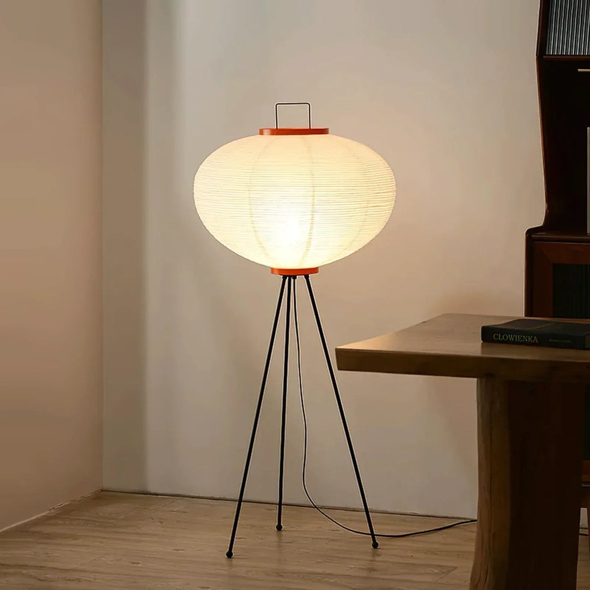 Lit Akari 10A 14A Paper Floor Lamp placed beside wooden side table minimalist interior