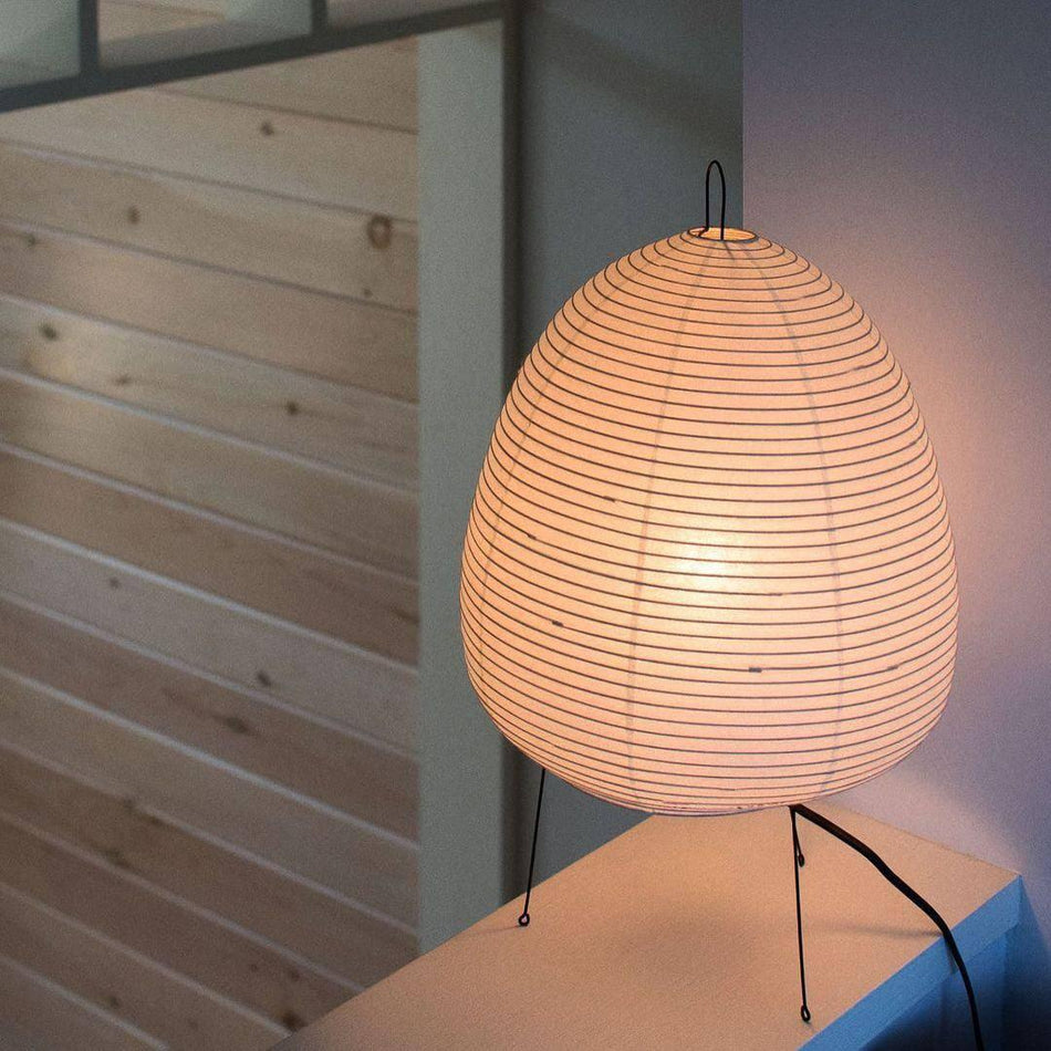 Akari Paper 1A Table Lamp standing near wooden panel sunlit room