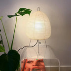Modern Japanese Paper Lantern Table Lamp Next to Green Plants