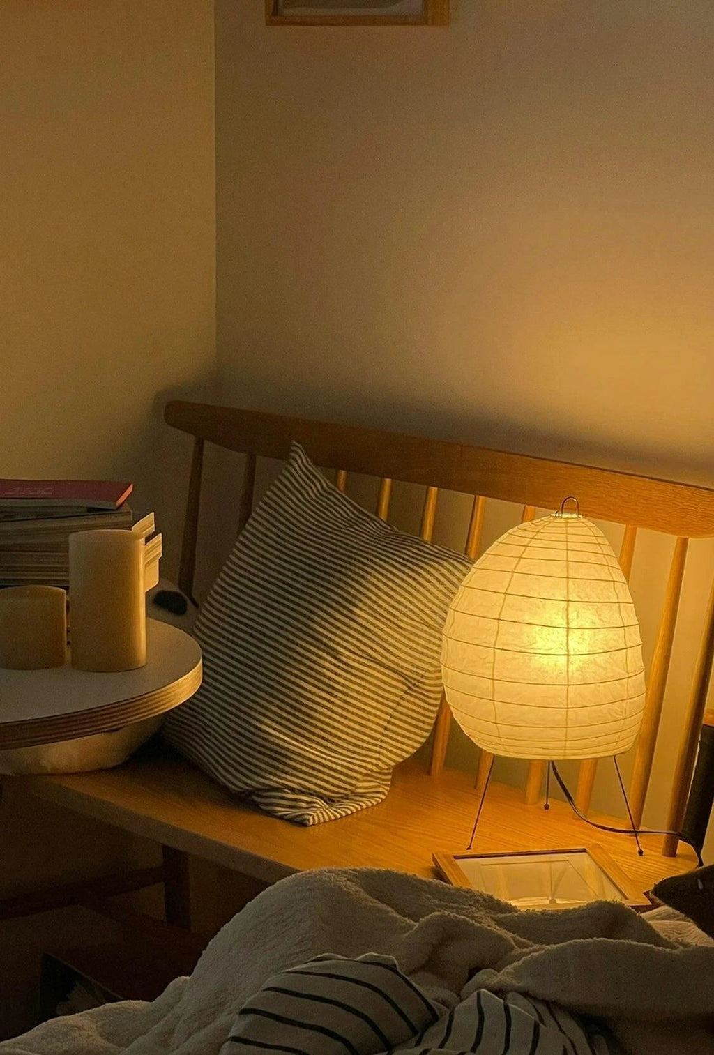 Illuminated Modern Paper Lantern Table Lamp Next to Wooden Bench