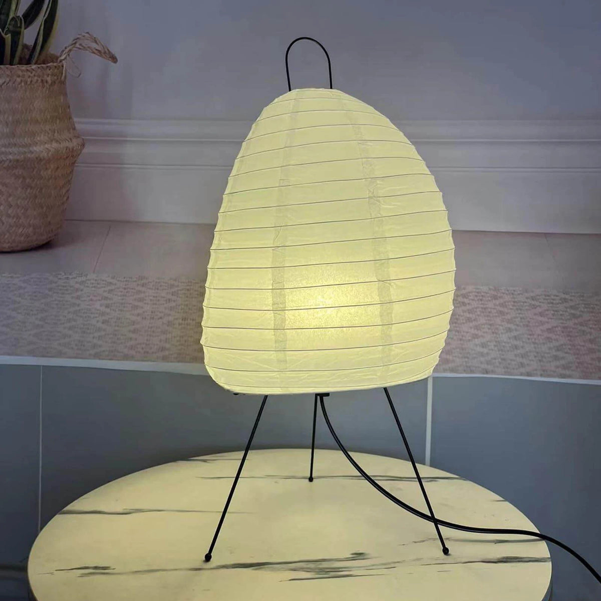 Illuminated Modern Paper Lantern Table Lamp on Marble Surface