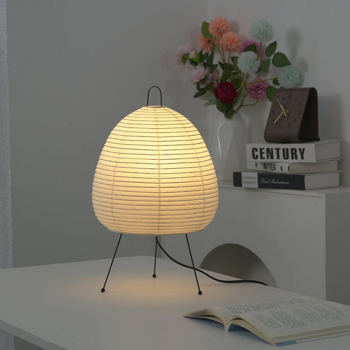 Lit Akari Paper 1A Table Lamp on desk decorated with fresh flower bouquet
