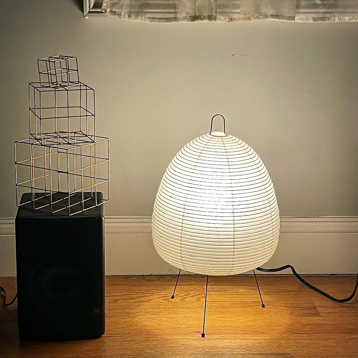 White shade Akari Paper 1A Table Lamp on wooden surface artistic interior
