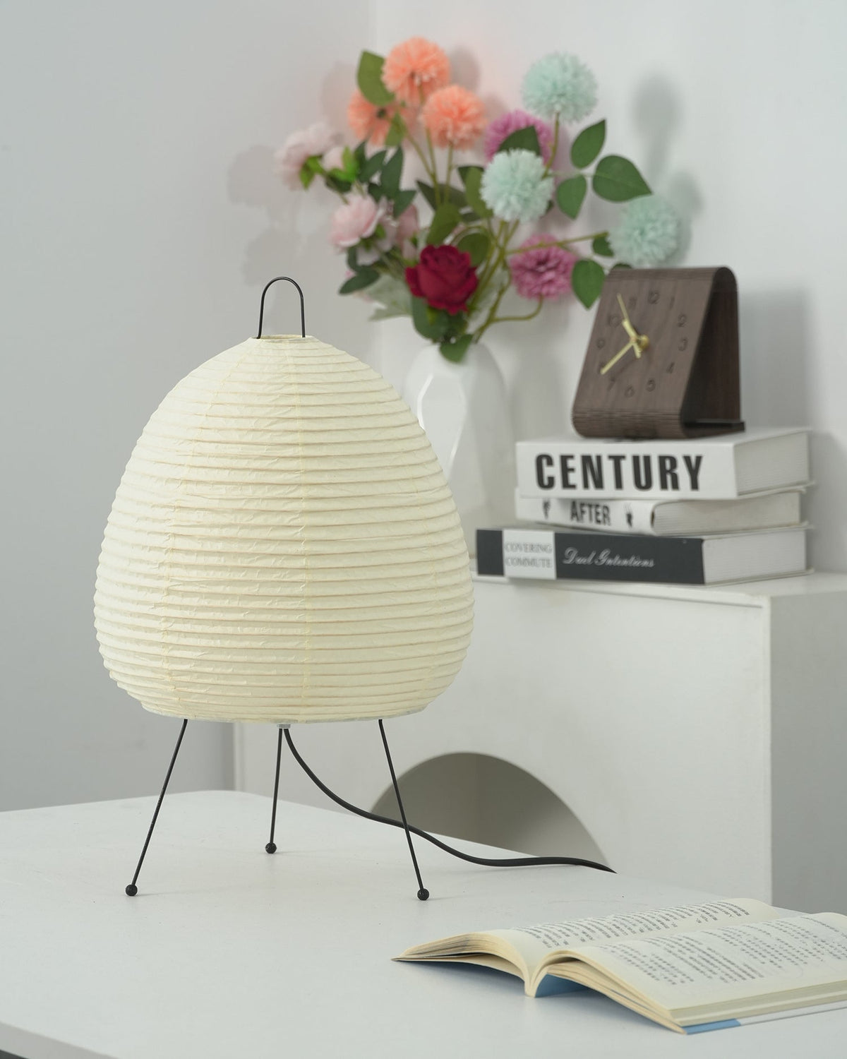 Akari Paper 1A Table Lamp on wooden reading table with open notebooks