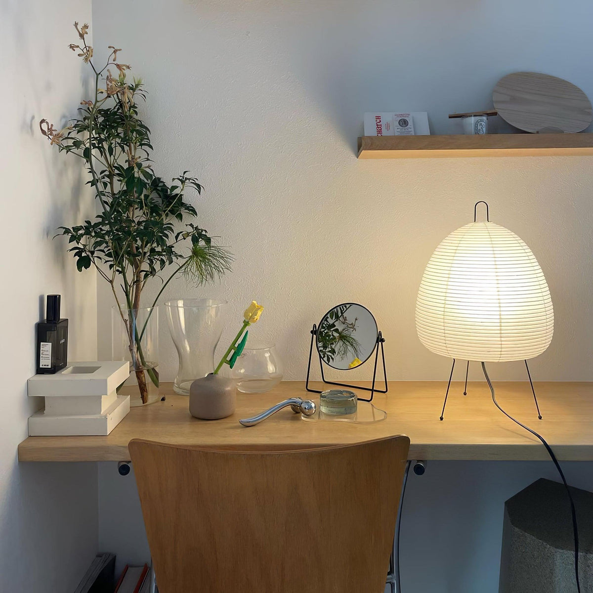 Akari Paper 1A Table Lamp illuminating wooden home office desk with decorations