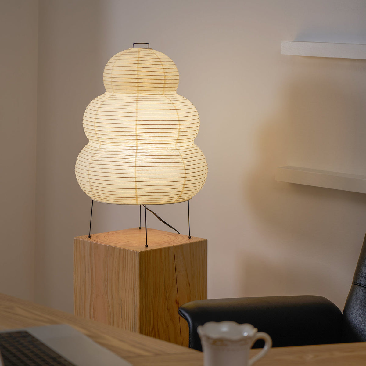 Akari Paper 25N Table Lamp set atop wooden cube pedestal modern room