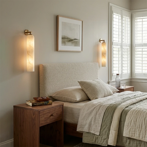 Pair of Cylindrical Alabaster Sconces Flanking Bedroom Bed