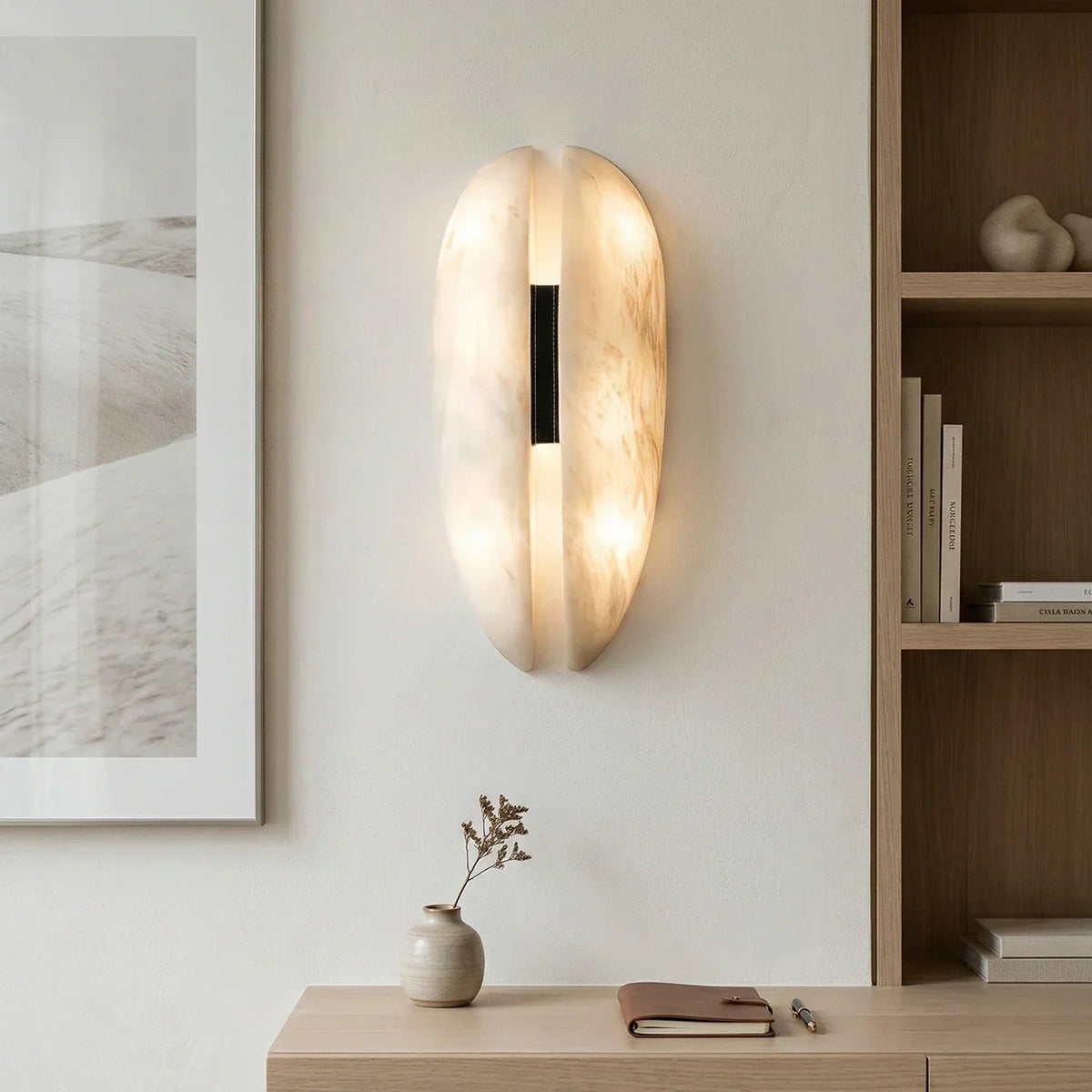 Split oval alabaster wall light beside built-in shelf neutral minimalist room