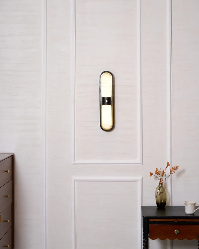 Modern Alabaster Double Oval Wall Sconce in Cozy Bedroom Setting