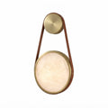 Modern Leather Strap and Alabaster Disc Wall Sconce with Brass Frame and Warm Light on Pure White Background   
