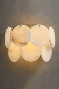 Illuminated Modern Alabaster Disc Wall Sconce Studio Shot on Grey Background