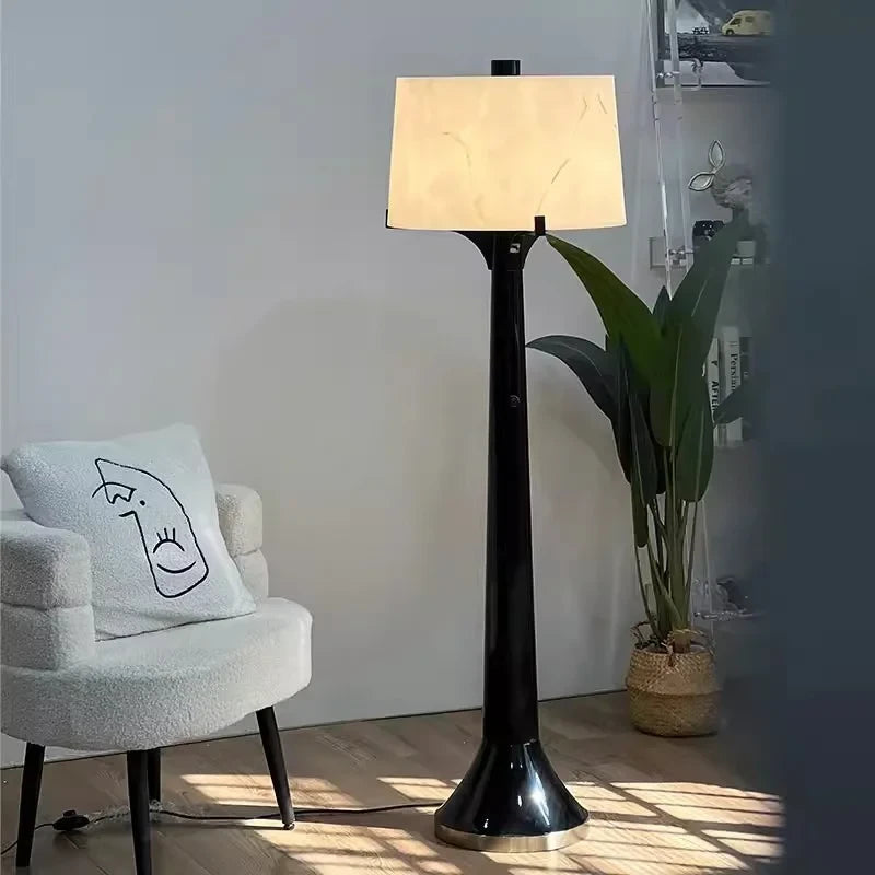 Modern Black Trumpet Base Floor Lamp Studio Shot with Minimalist Chair on White Background