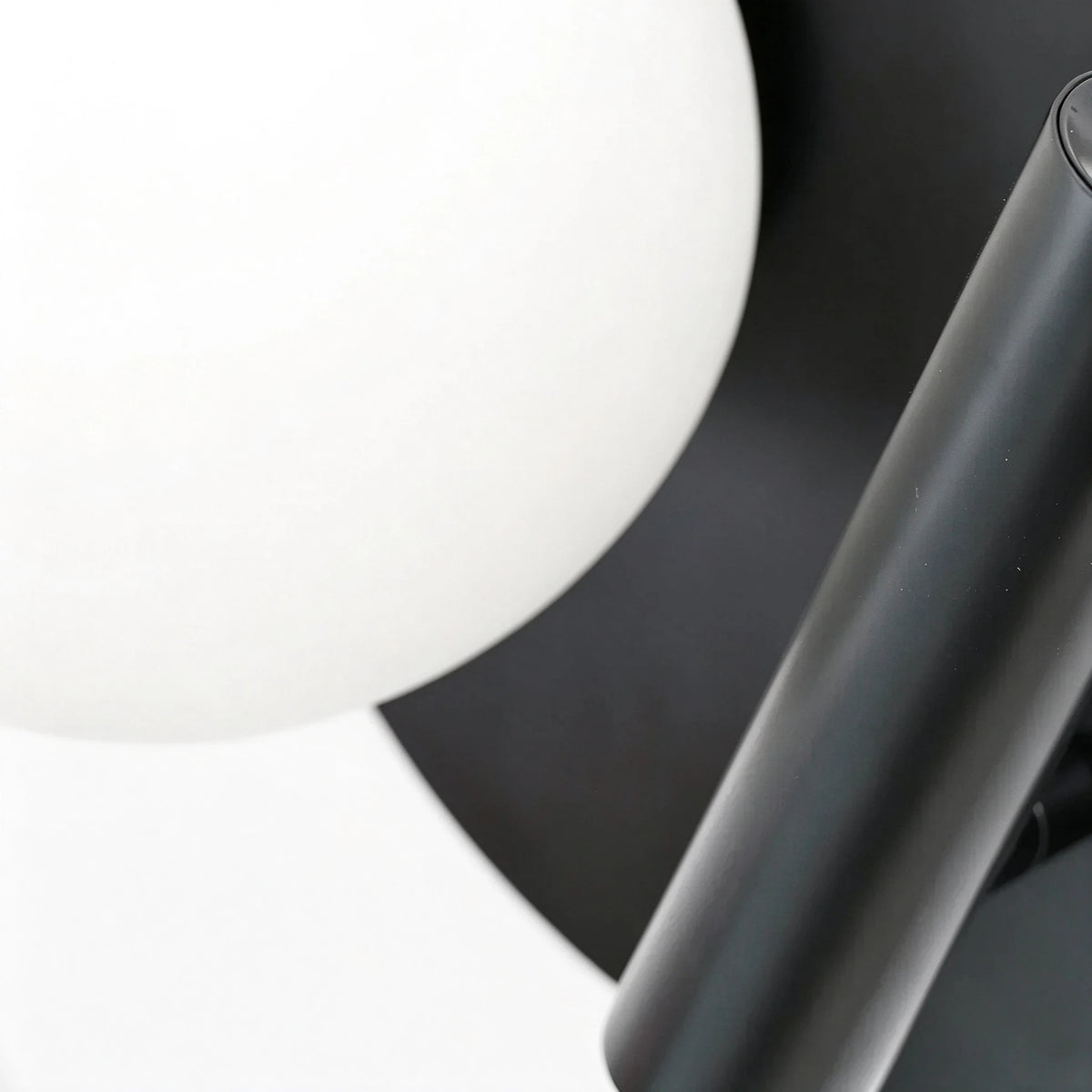 Close Up View of Spherical Glass Shade and Black Base Connection Details