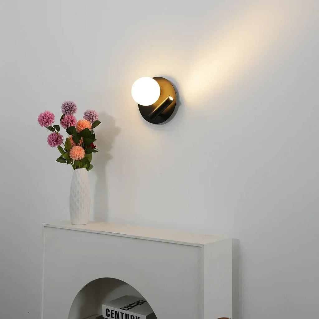 Modern Black Disc Base Wall Sconce in Minimalist Living Room Setting