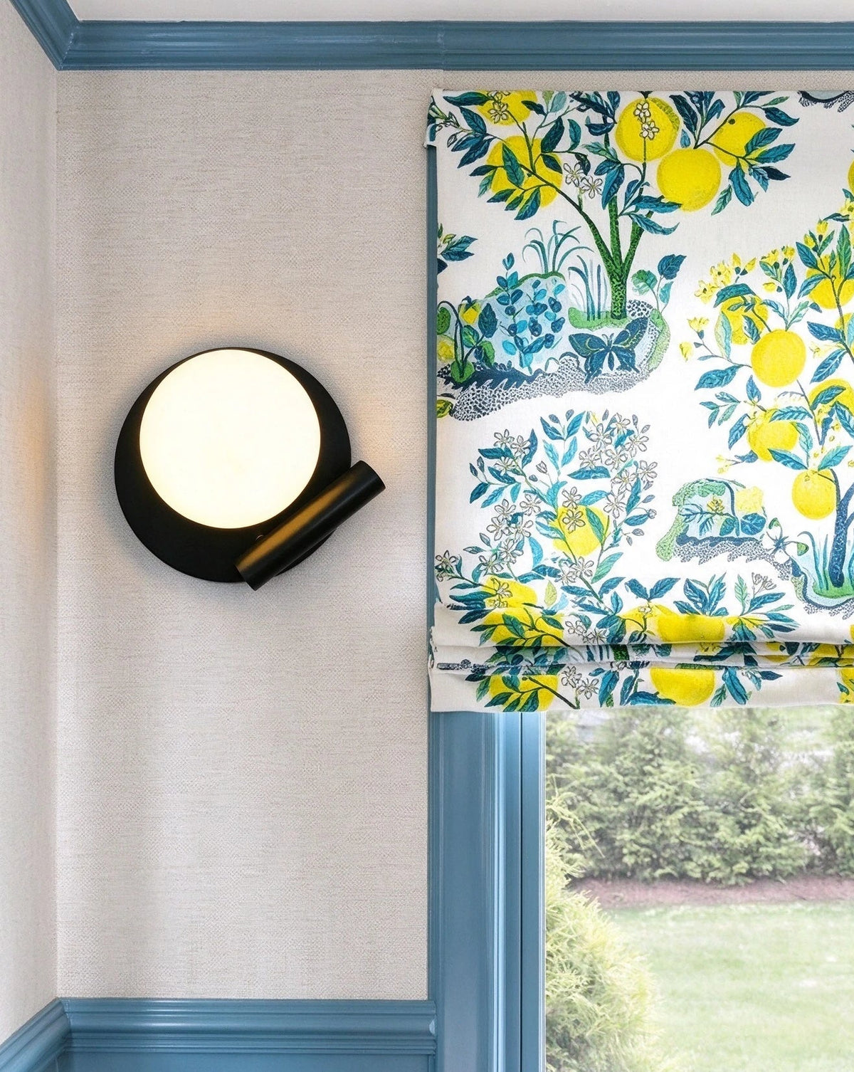 Modern Black Disc Base Wall Sconce in Bright Interior Space