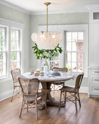 Modern White Disc Chandelier Over Round Dining Table