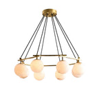 Modern Brass Ring and Multi-Sphere Alabaster Chandelier with Warm Light on Pure White Background