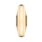 Modern Hexagonal Alabaster and Brass Trim Wall Sconce with Warm Light on Pure White Background
