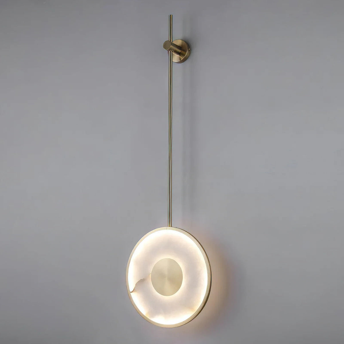 Illuminated Modern Brass Pendant Rod Alabaster Wall Sconce Studio Shot on White Background