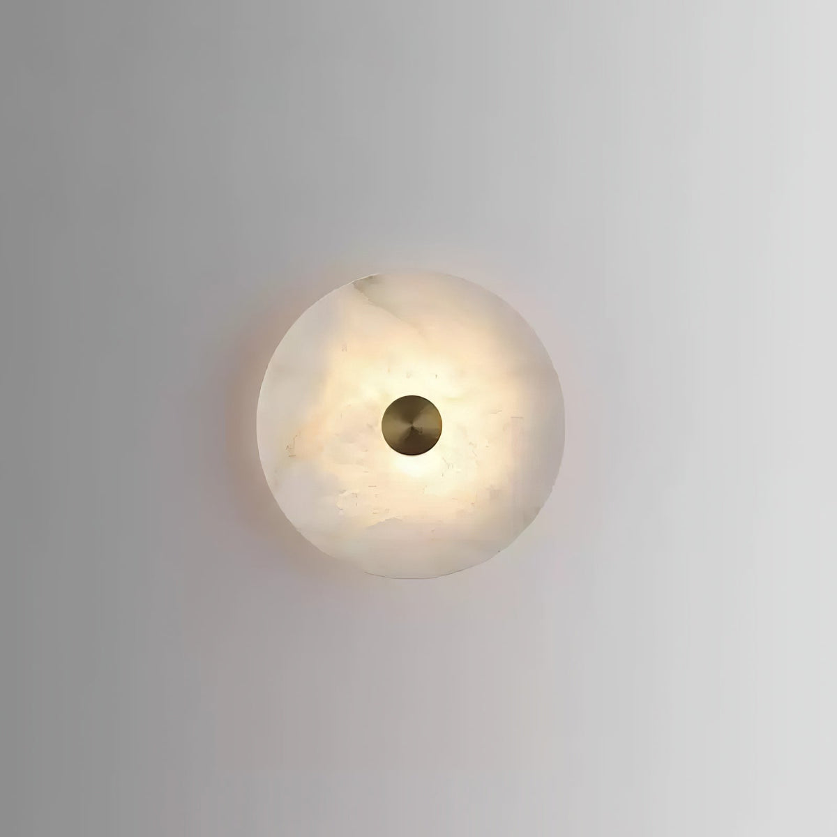 Single glowing Alabaster Platter Sconce plain light grey wall background
