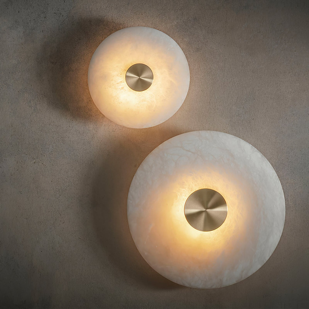 Dual size Alabaster Platter Sconces lit dark grey accent wall