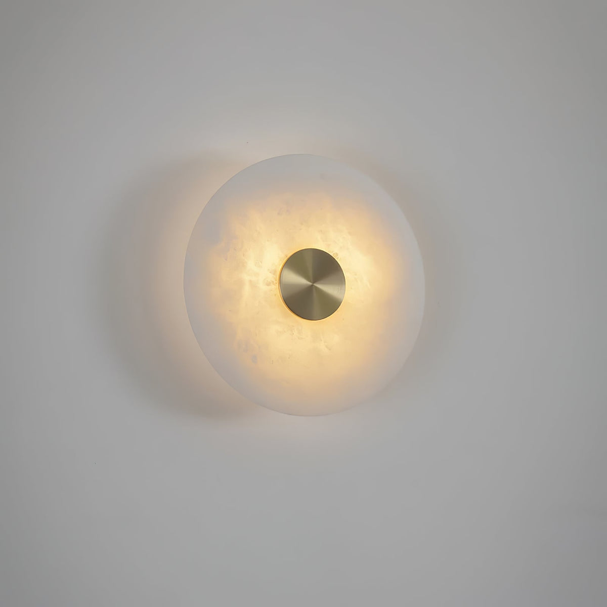 Close front view illuminated Alabaster Platter Sconce brass center detail