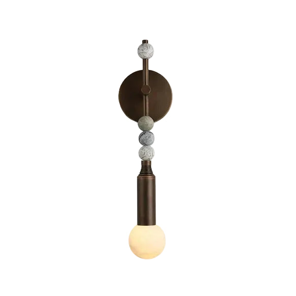 Modern Beaded Marble and Metal Rod Wall Sconce with Spherical Glass Bulb and Warm Light on Pure White Background   