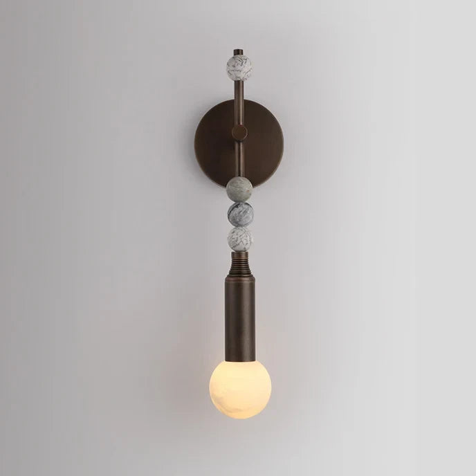 Illuminated Modern Beaded Marble Wall Sconce Studio Shot on White Background   