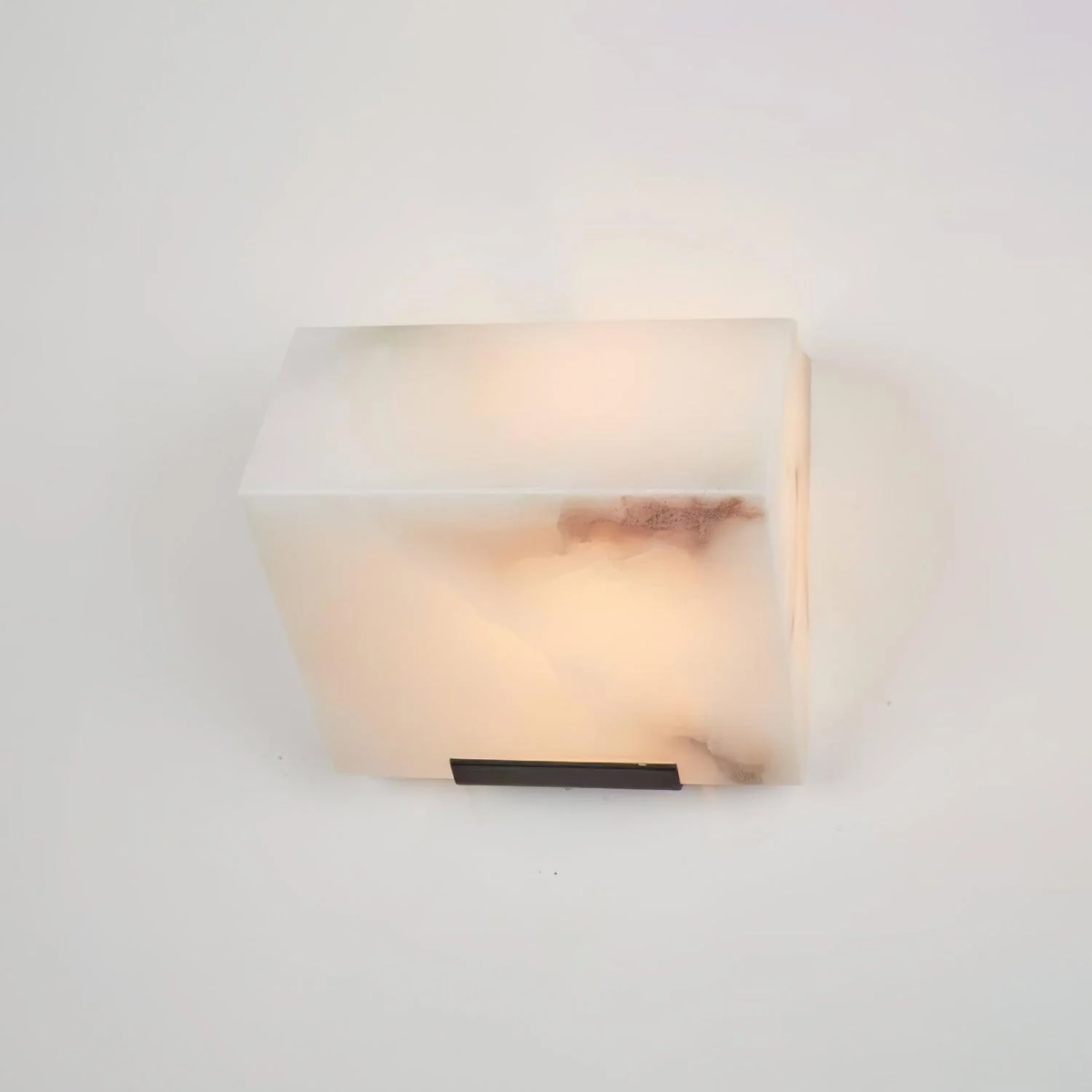 Single tier natural alabaster wall sconce unlit white background closeup photo