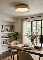 Modern Wood and Terrazzo Disc Ceiling Light Over Dining Table in Elegant Setting