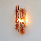 Side View of Illuminated Modern Amber Round Plate Art Glass Wall Sconce