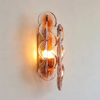 Front View of Illuminated Modern Amber Round Plate Art Glass Wall Sconce