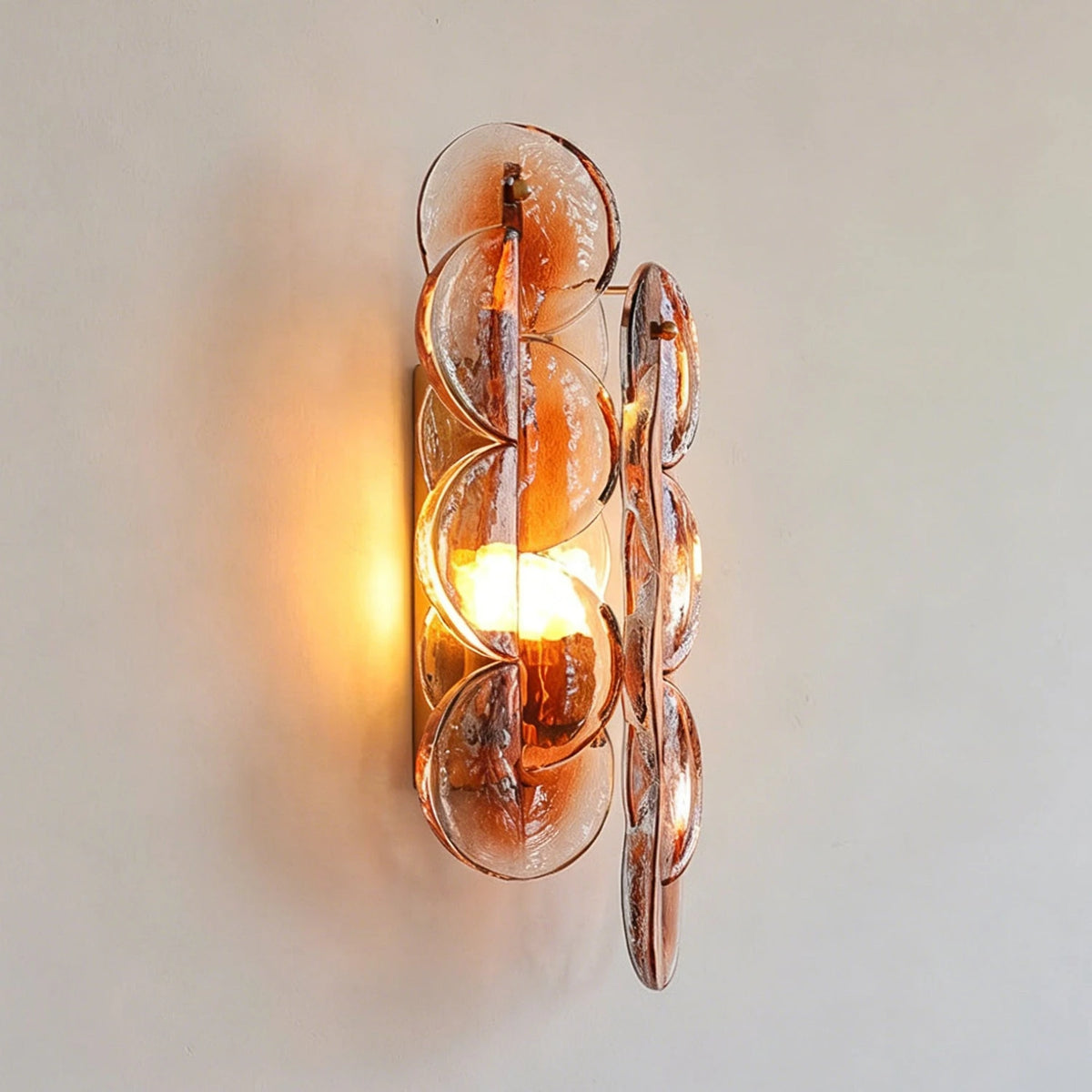 Front View of Illuminated Modern Amber Round Plate Art Glass Wall Sconce
