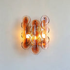 Studio Display of Illuminated Modern Amber Round Plate Art Glass Wall Sconce