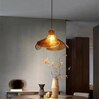Illuminated Modern Brass Amber Petal Art Glass Pendant Light Studio Shot on Dark Background