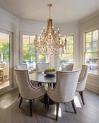Traditional Crystal Chandelier Over Dining Set by Window