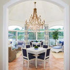 Crystal Chandelier Over Dining Table in Bright Sunroom