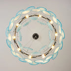 Upward View of Illuminated Modern Teal Layered Wave Disc Chandelier Studio Shot