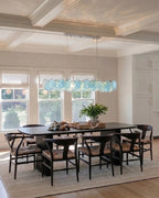 Modern Silver Frame Teal Wave Disc Linear Chandelier Over Dining Table