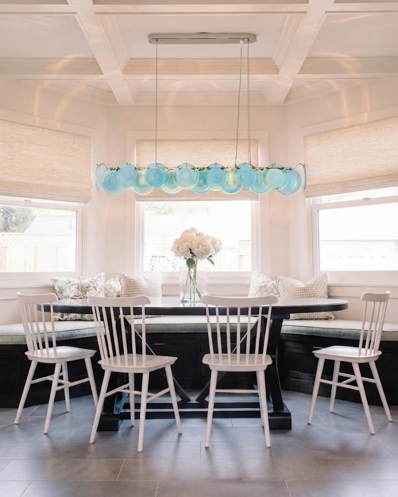 Modern Silver Frame Teal Wave Disc Linear Chandelier in Bright Dining Area