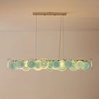 Front View of Modern Silver Frame Teal Wave Disc Linear Chandelier Studio Display