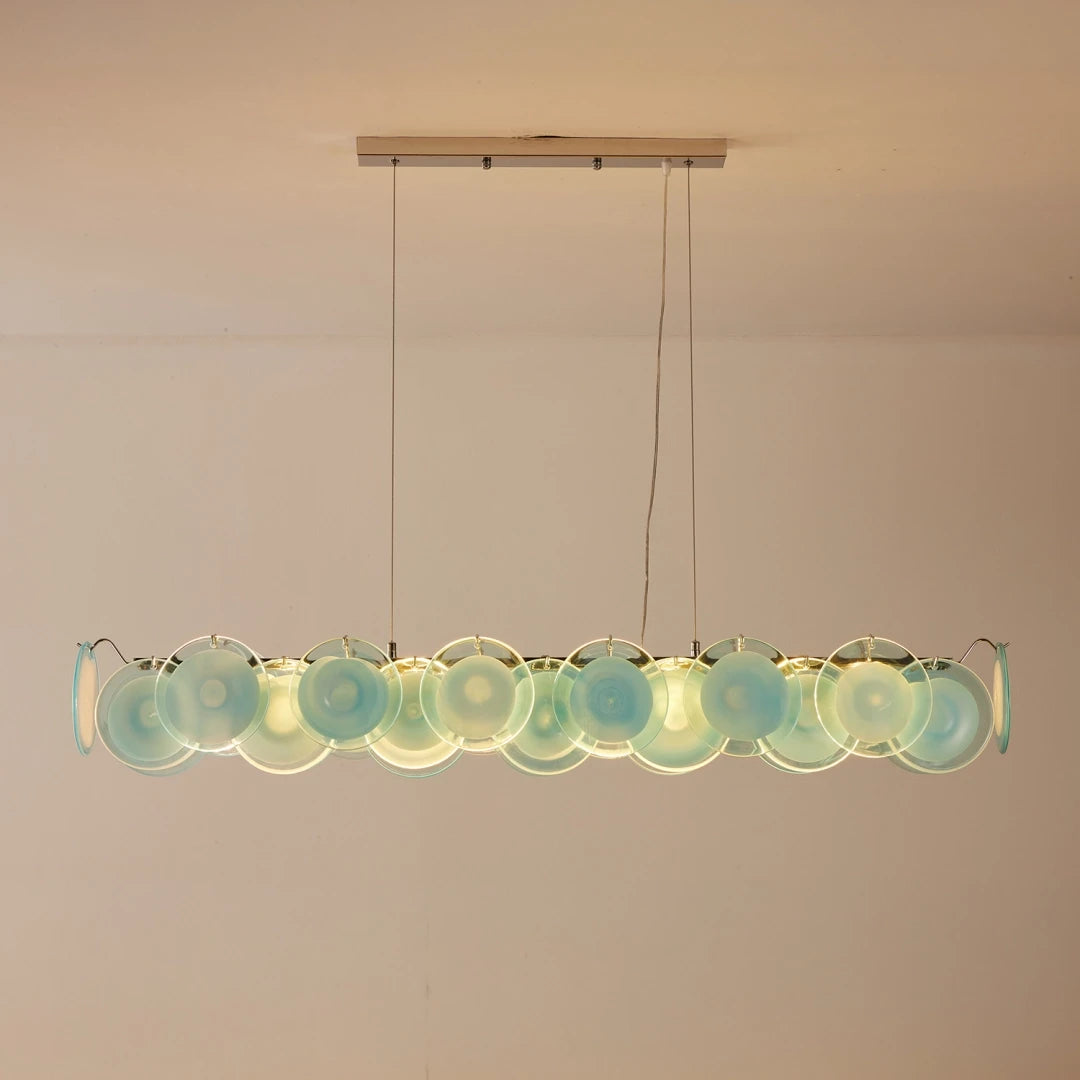 Front View of Modern Silver Frame Teal Wave Disc Linear Chandelier Studio Display