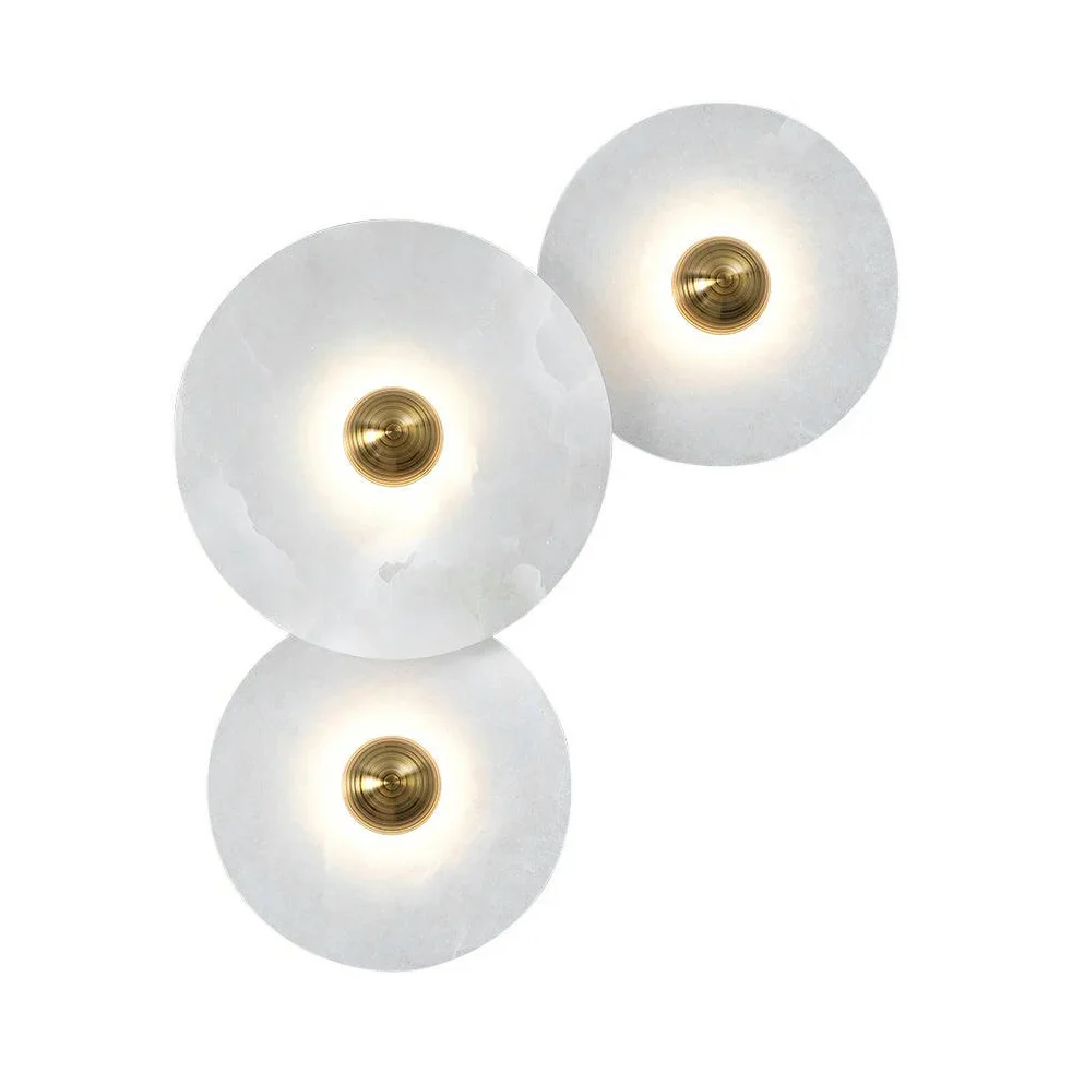 Two staggered glowing Solaris alabaster disc wall lamps set