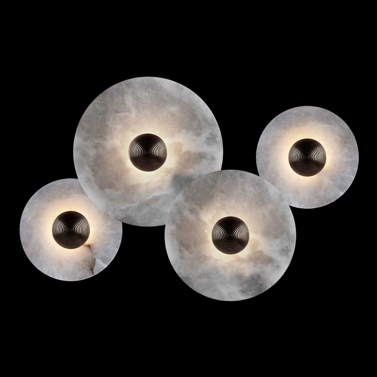 Three warm-lit Solaris round wall lamps with alabaster stone shades interior shot