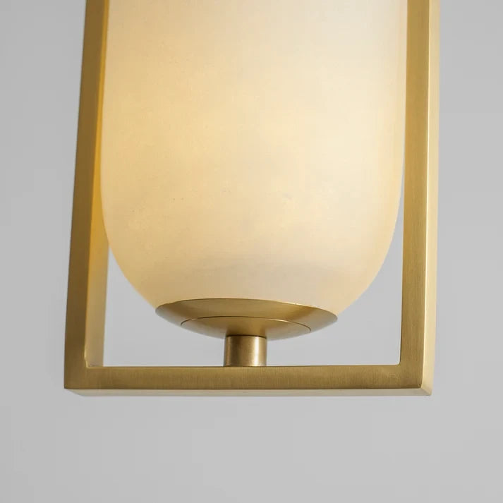 Close Up View of Glowing Alabaster Cylinder and Brass Arch Base